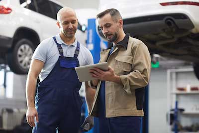 auto mechanic discussing repairs with a customer